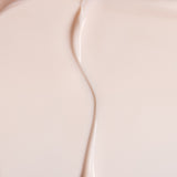 Close-up of The Body Shop Vitamin E Day cream with a subtle gradient.