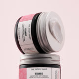 Two jars of The Body Shop Vitamin E Moisture Day Cream on a pink background