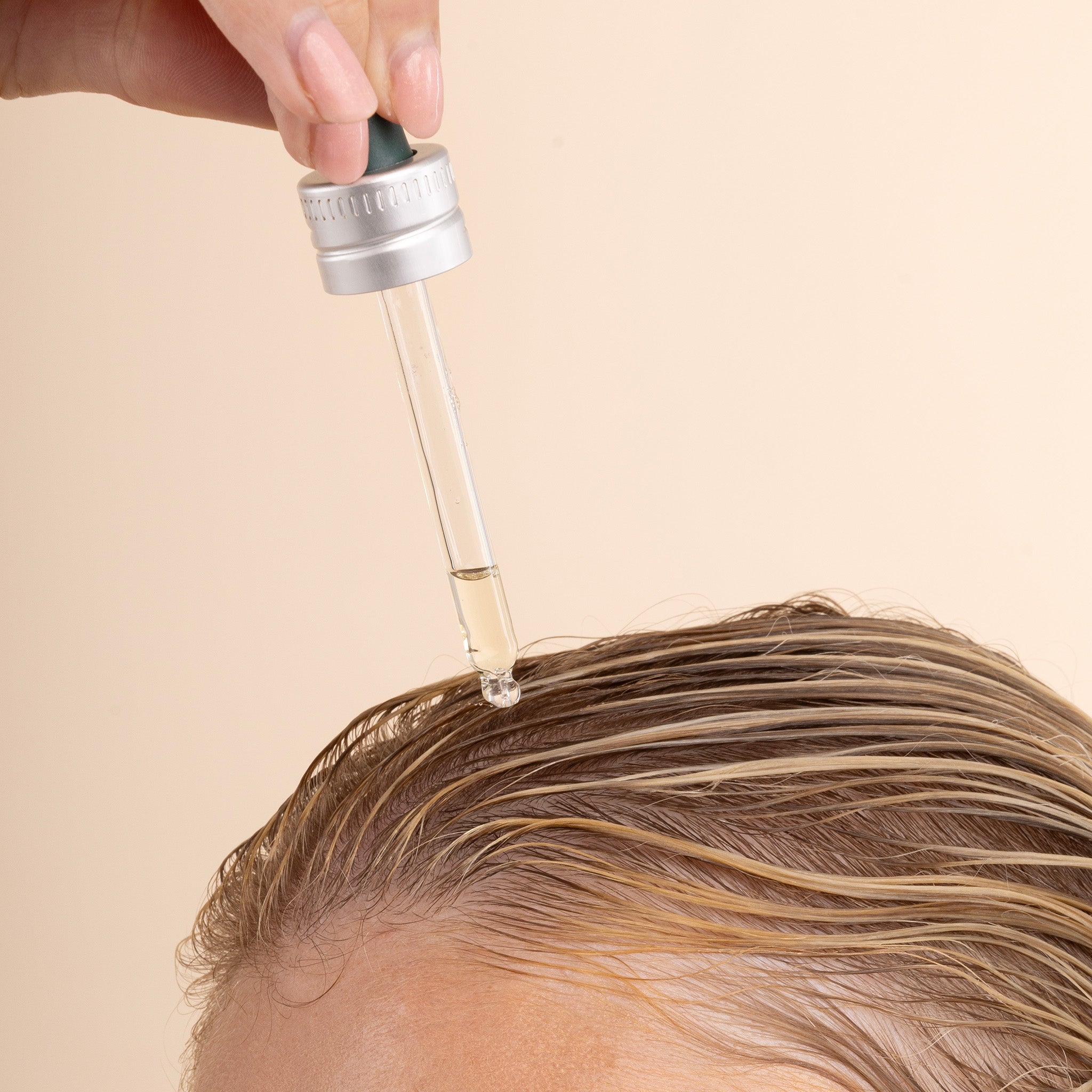 The Body Shop Ginger Scalp Serum being applied to wet hair
